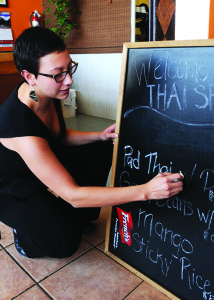 Photo: Kelly Gary Andrea Alvarez writes the night's special for Thai Spice on the board Thursday.